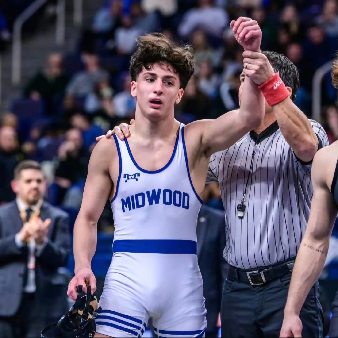 Midwood wrestler wearing a custom blue and white MyHOUSE singlet